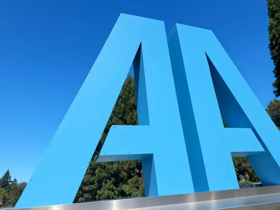 All Around Mechanical's blue interlocking AA monument sign standing against a clear sky