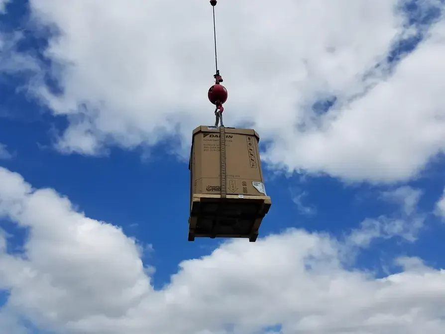 New Daikin equipment lifted by crane during an All Around Mechanical install