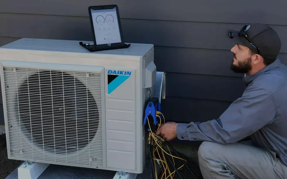 An All Around Mechanical technician commissioning a new Daikin ductless heat pump in SW Washington