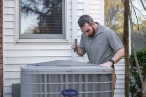 homeowner inspecting a clean HVAC air filter indoors - how to maintain your heating and cooling system